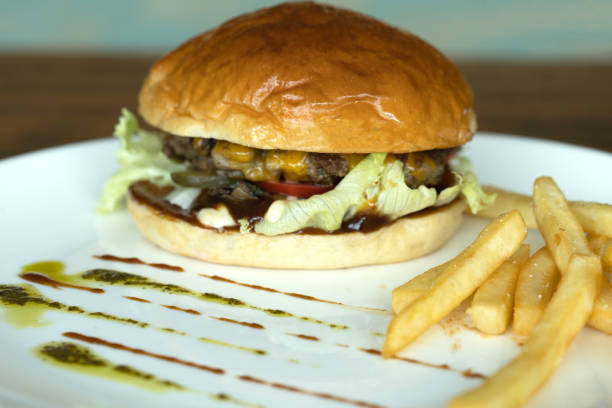 istock Beef burger and french fries appetizing on the white disc. 1136840137