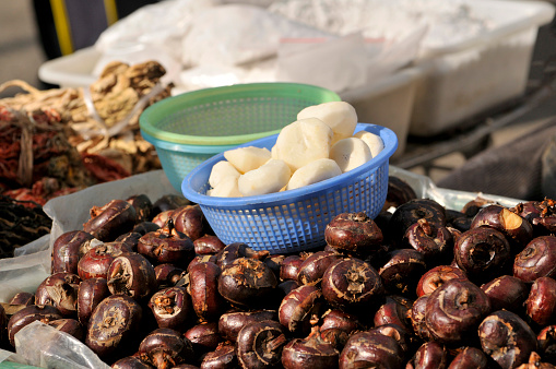 Water chestnuts being peeled at the market in Asia