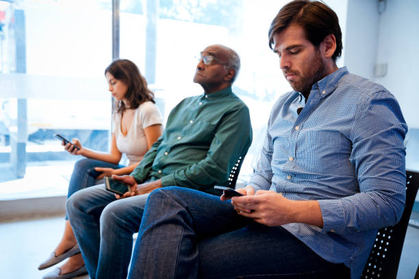 istock Multi-ethnic people sitting at waiting room 1136841523