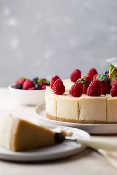 istock Piece of birthday cake with whole cake on table side view 1136842081