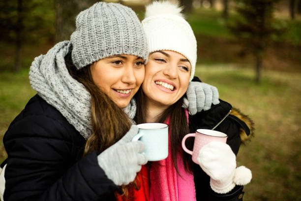 Two young women with hot beverage
