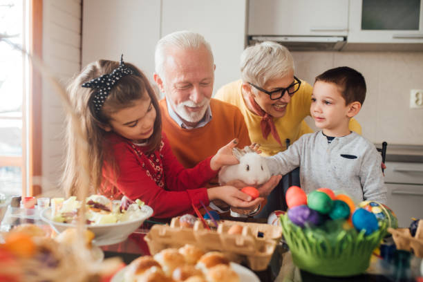 istock Happy family petting rabbit 1136842902