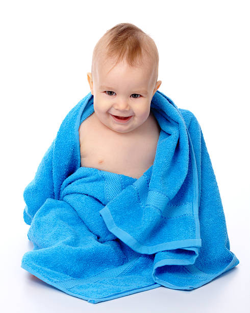Cute child wrapped in blue towel stock photo