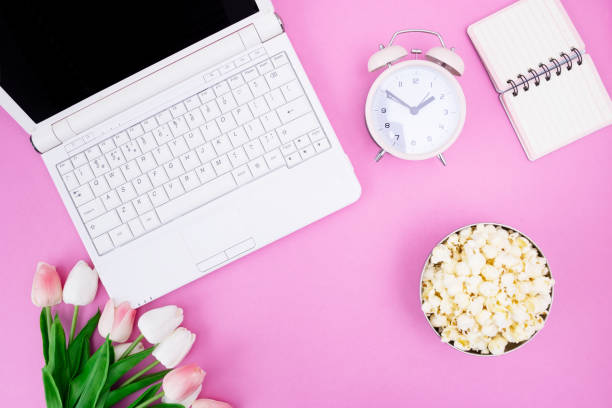 istock Notebook Notepad Alarm Clock Bouquet of tulips Popcorn in a bowl on the desktop 1136844567