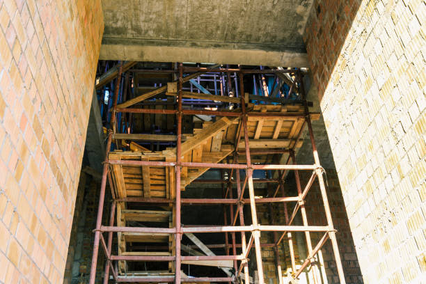 istock Constructions on the building under construction. Iron lessa and wooden stairs. Construction of the building. Yellow brick 1136846288