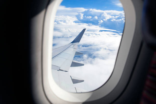 istock Airplane wing out of window and beautiful cloud 1136846381