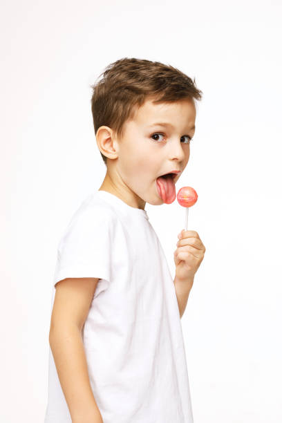 little beautiful boy with a lollipop on a white background
