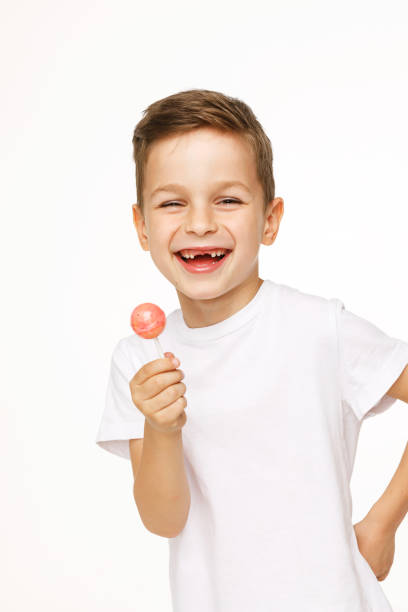 little beautiful boy with a lollipop on a white background