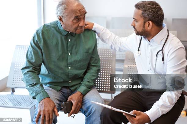 Doctor Consoling Sad Senior Male Patient Stock Photo - Download Image Now - Doctor, Patient, Senior Adult