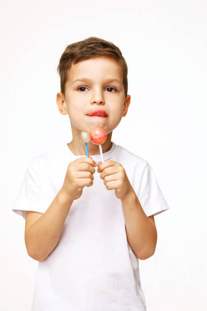 istock little boy with a lollipop on a white background 1136849350