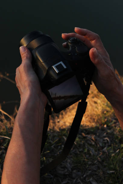 istock Senior woman hands holding a camera 1136850604