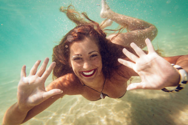 istock Cute Girl Swimming Under Sea 1136850699