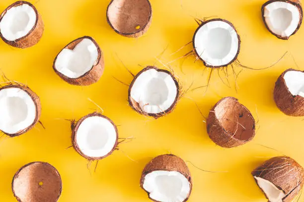 Summer composition. Coconut pattern on yellow background. Summer concept. Flat lay, top view