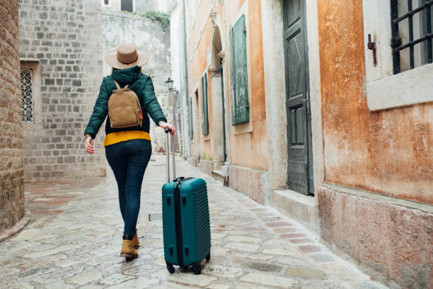 istock Girl pulling luggage in the city 1136850999