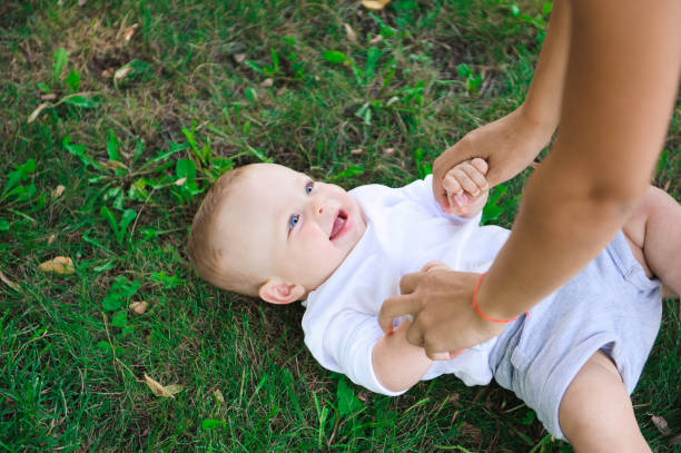 istock Cute cheerful child with mother play outdoors in park 1136852056