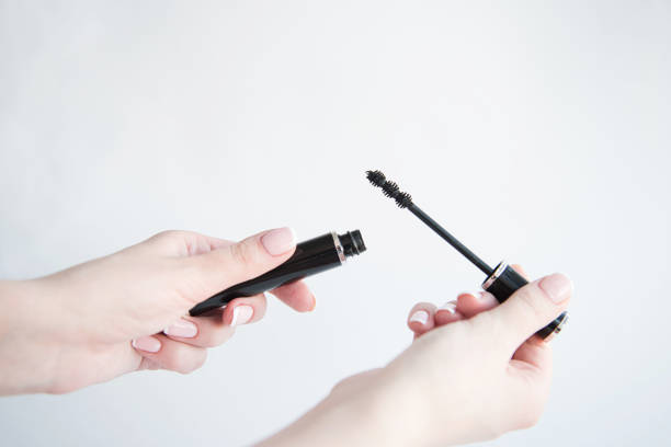 istock Hands holding a mascara on white background. Make-up And Cosmetics Concept. 1136852217