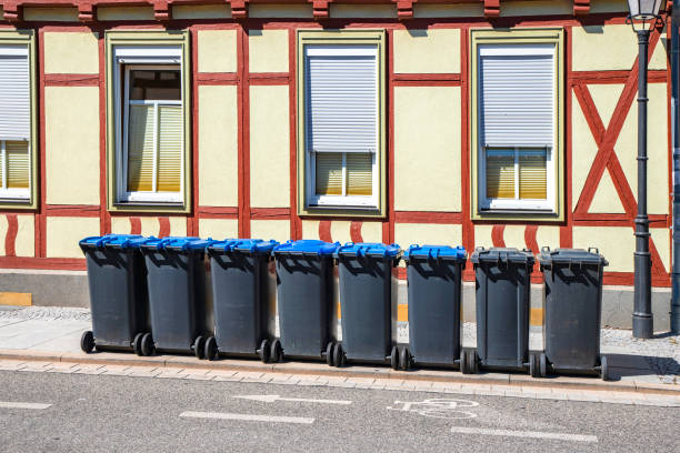 istock Garbage bins on the street outside an old house 1136852325