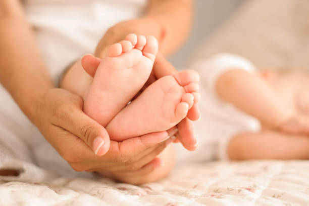 istock little baby feet in his mom's hands 1136852374