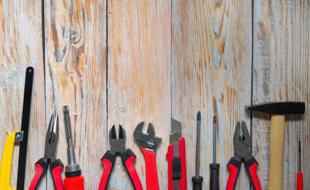 istock Carpenter working tools set on old vintage wooden background. Tools and workbench from the workshop. 1136852522