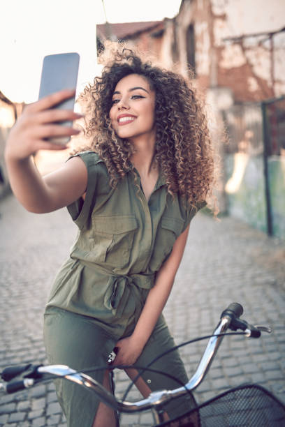 istock Cute Female Cyclist Taking  Selfie 1136853564