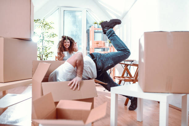 istock Boyfriend Diving In Box While Girlfriend Watches 1136853799