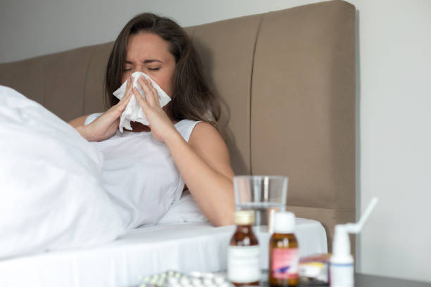 istock Young woman sneezing 1136855228