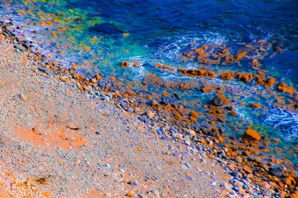 blue water at the ocean with rock and stone in summer