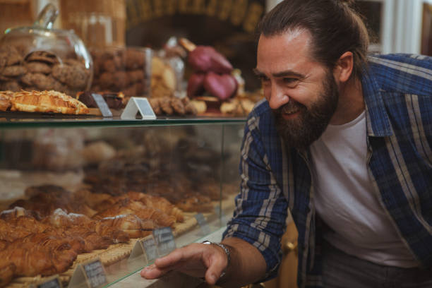 istock Handsome mature man shopping at bakery 1136856855