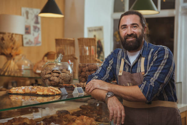 istock Mature male baker working at his shop 1136856876