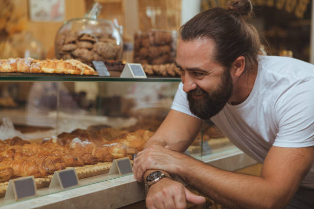 istock Handsome mature man shopping at bakery 1136856913