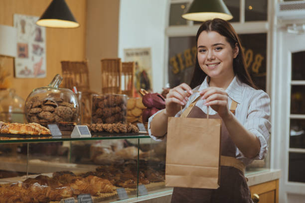 istock Lovely female baker at her shop 1136856986
