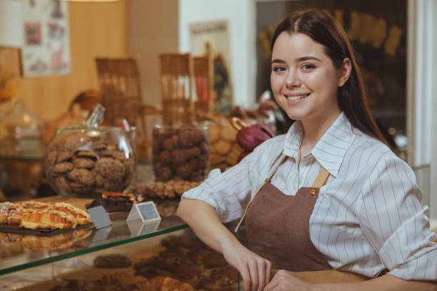 istock Lovely female baker at her shop 1136857010