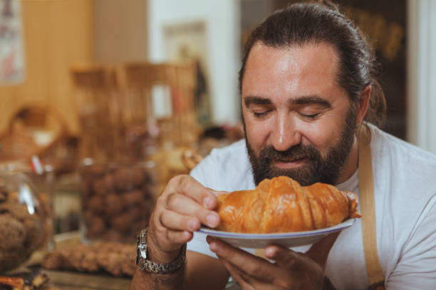 istock Mature male baker working at his shop 1136857037