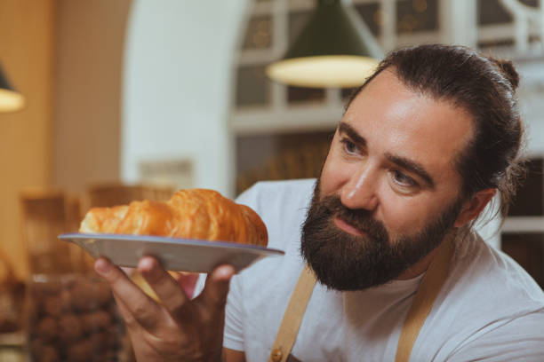 istock Mature male baker working at his shop 1136857052