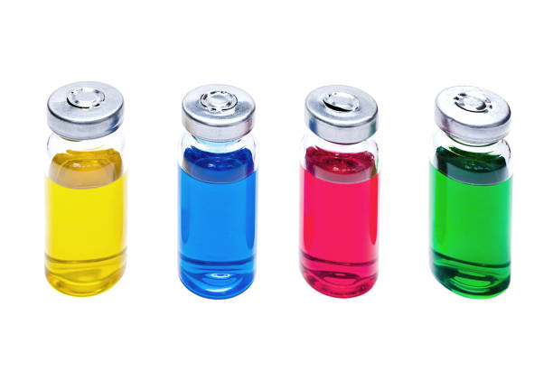 istock Glass vials with multicolored vaccine on white background 1136857899