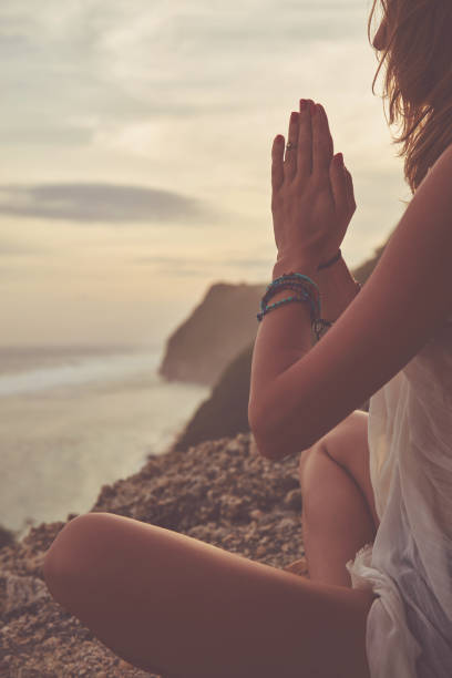 istock Young woman practicing yoga - meditation on the beach. 1136858014