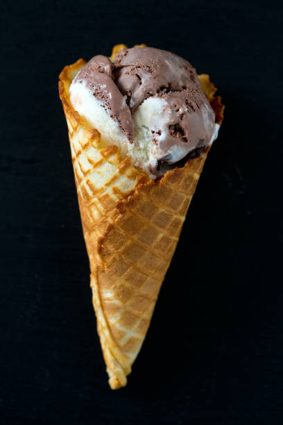 istock chocolate and vanilla ice cream in waffle cones 1136858057