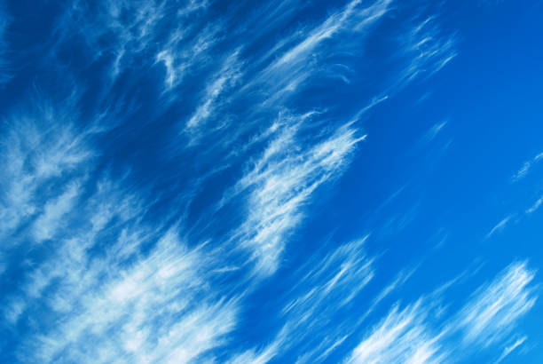 Cirrus clouds in blue sky. High wind, sunny day