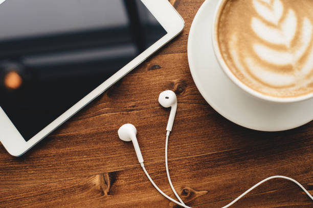 istock Tablet, headphones and cappuccino 1136859807