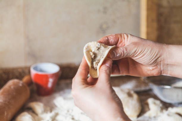 istock hands of woman make dumpling over granite table 1136860145
