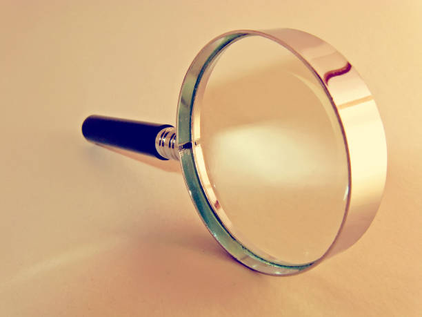 istock Magnifying glass on a monochromatic background 1136860240