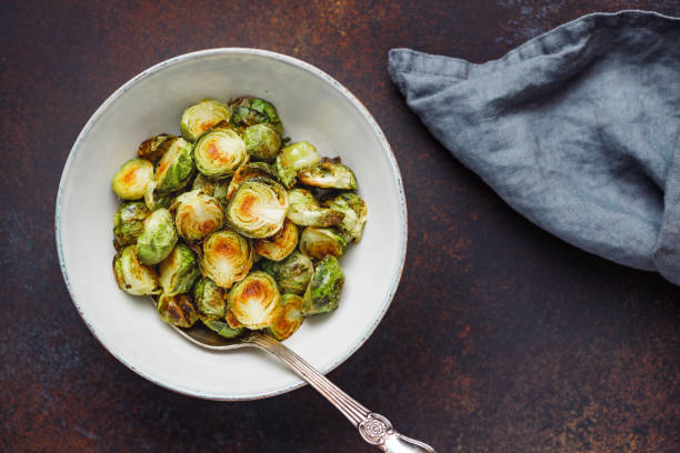 istock View from above on a ceramic bowl with roasted brussel sprouts on a table. The concept of healthy vegetarian eating. 1136861403