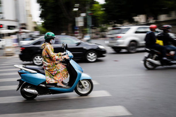 Hanoi, Vietnam - November, 26. 2018: Vietnamese woman buying groceries in Hanoi Street