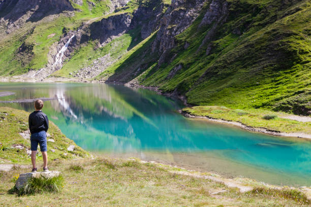 istock A boy at the alpine lake 1136861551