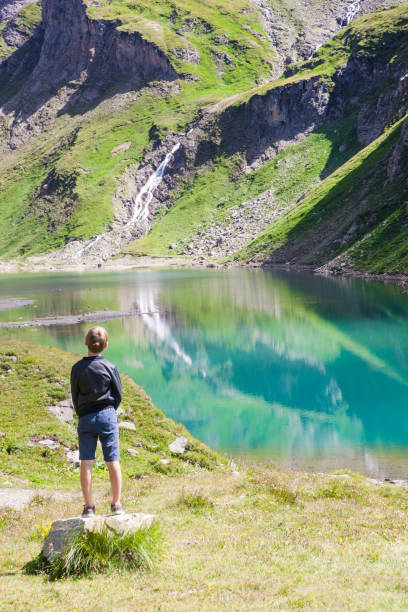 istock A boy at the alpine lake 1136861594