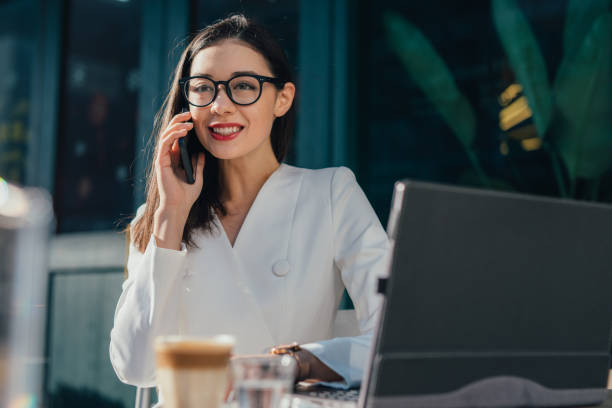 istock Charming businesswoman is using phone 1136863026