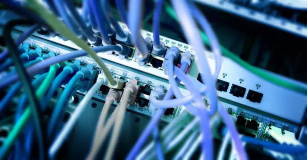 network server panel with ethernet cable on switches in a school system, color effect, selected focus, narrow depth of field