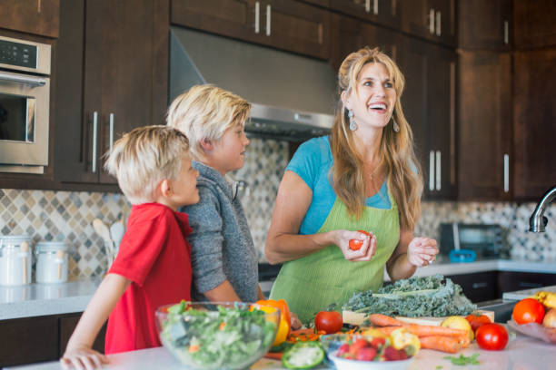 istock Boys are hanging out in the kitchen with mom. 1136866114
