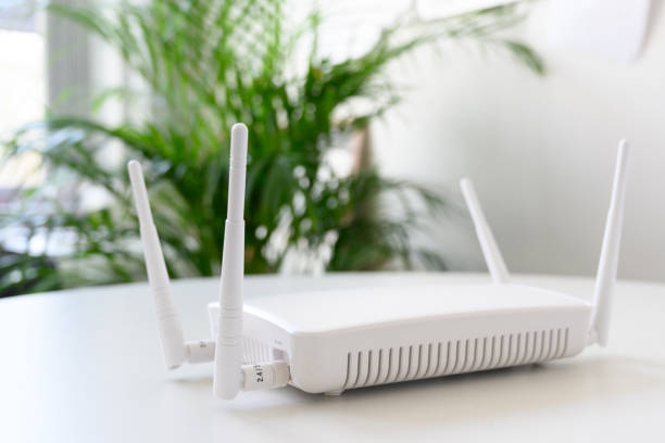 istock white wireless internet router with connection for ethernet and console on a table in the office, copy space, 1136866123
