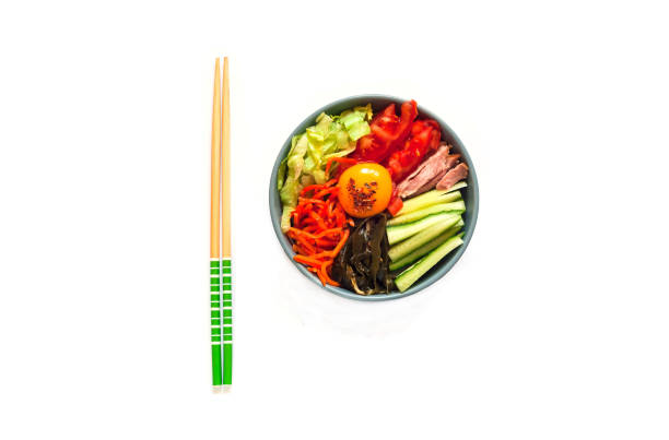 Traditional dish of Korean cuisine. Bibimbap with beef, vegetables and egg on white isolated background.